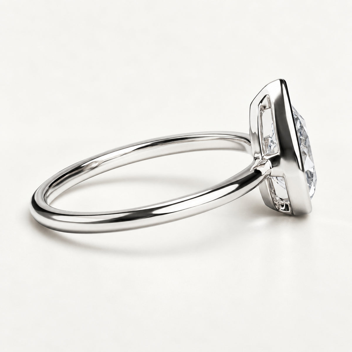 The Flow pear-cut lab-grown diamond bezel ring — White Gold, side view of the low-profile setting